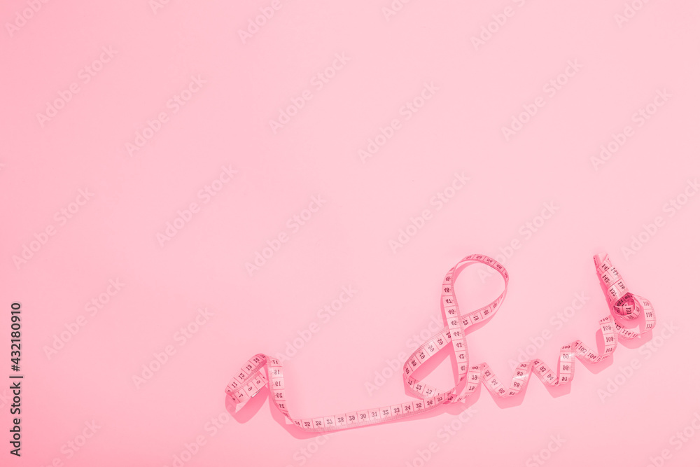 International Woman Day March. World Mother Day May. Centimeter tape twisted in the shape of number 8 on pink background. Greeting card with copy space text. Hello spring. Fitness and sewing hobby International Woman Day March. World Mother Day May. Centimeter tape twisted in the shape of number 8 on pink background. Greeting card with copy space text. Hello spring. Fitness and sewing hobby