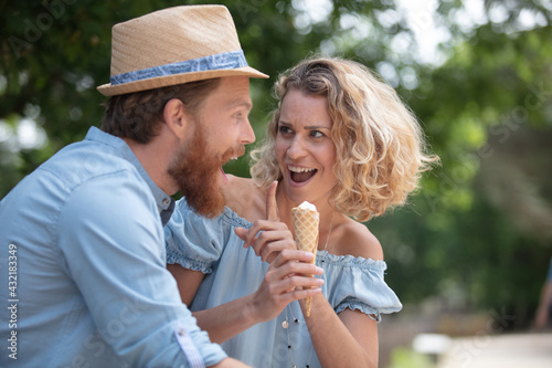 couple eating an ice cream in the park