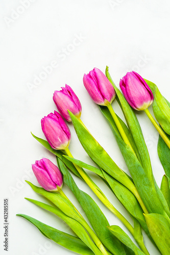 Fototapeta Naklejka Na Ścianę i Meble -  Pink tulips on a marble surface