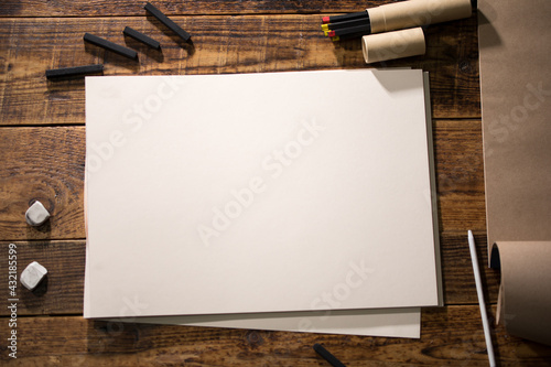 Close-up view of a painter on a white sheet. A man holds a pencil and draws. Drawing and creativity concept.