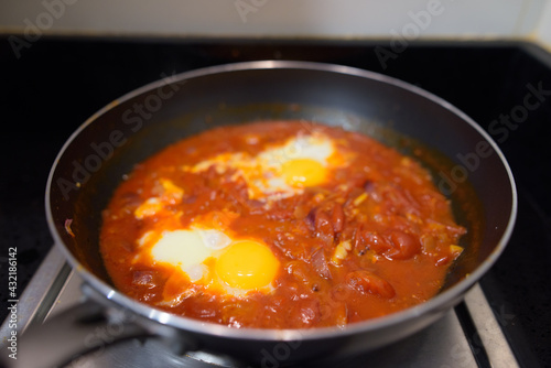 Shakshouka spicy tomato stew with chicken eggs traditional vegetarian dish