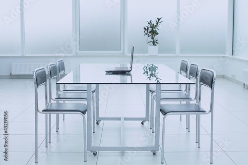 Spacious  bright  modern office space. Glass table. A place to learn at work.