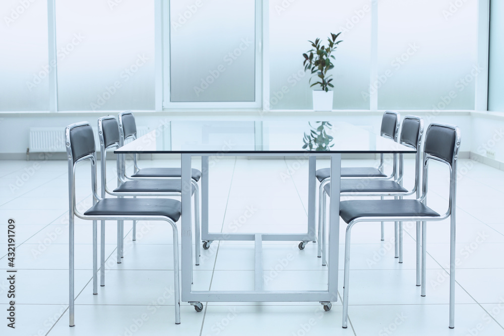 Spacious, bright, modern office space. Glass table. A place to learn at work.