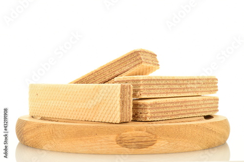 Several sweet vanilla waffles on a round wooden tray, close-up, isolated on white.