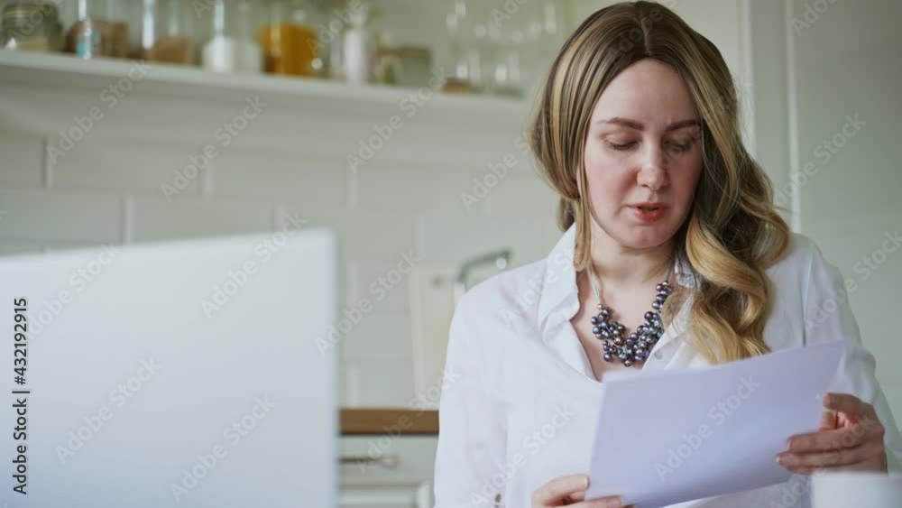 Woman talking to her colleagues in video conference at home. Woman talking to her colleagues in video conference at home.