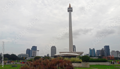 Visible from behind the entrance of the historical monas tour with a beautiful foreground of plants