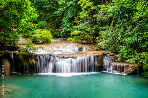 Waterfall and blue emerald water color in Erawan national park. Erawan Waterfall  Beautiful nature rock waterfall steps in tropical rainforest at Kanchanaburi province  Thailand