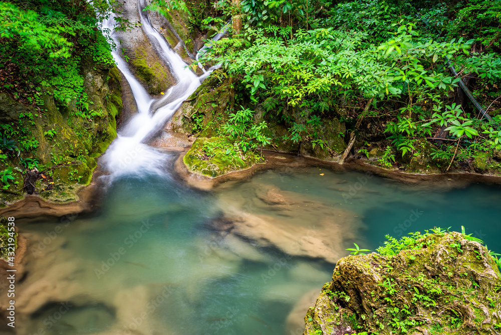 Waterfall and blue emerald water color in Erawan national park. Erawan Waterfall, Beautiful nature rock waterfall steps in tropical rainforest at Kanchanaburi province, Thailand Waterfall and blue emerald water color in Erawan national park. Erawan Waterfall, Beautiful nature rock waterfall steps in tropical rainforest at Kanchanaburi province, Thailand