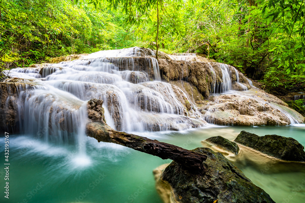 Obraz premium Waterfall and blue emerald water color in Erawan national park. Erawan Waterfall, Beautiful nature rock waterfall steps in tropical rainforest at Kanchanaburi province, Thailand