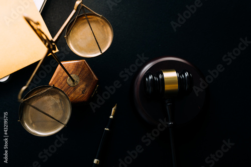 Business and lawyers discussing contract papers with brass scale on desk in office. Law, legal services, advice, justice and law concept picture with film grain effect