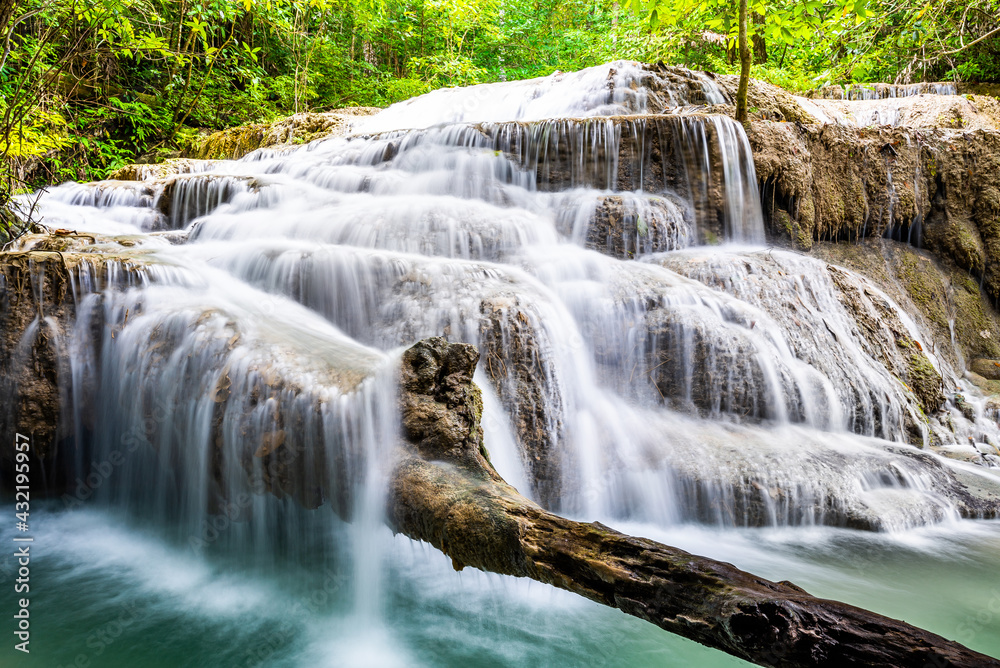 Obraz premium Waterfall and blue emerald water color in Erawan national park. Erawan Waterfall, Beautiful nature rock waterfall steps in tropical rainforest at Kanchanaburi province, Thailand