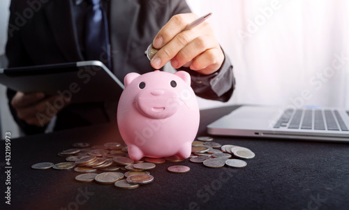 Male hand putting coins with money stack step growing growth and dollar bag. saving money, Concept finance business investment.