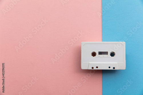 vintage white cassette tape on a blue and pink background