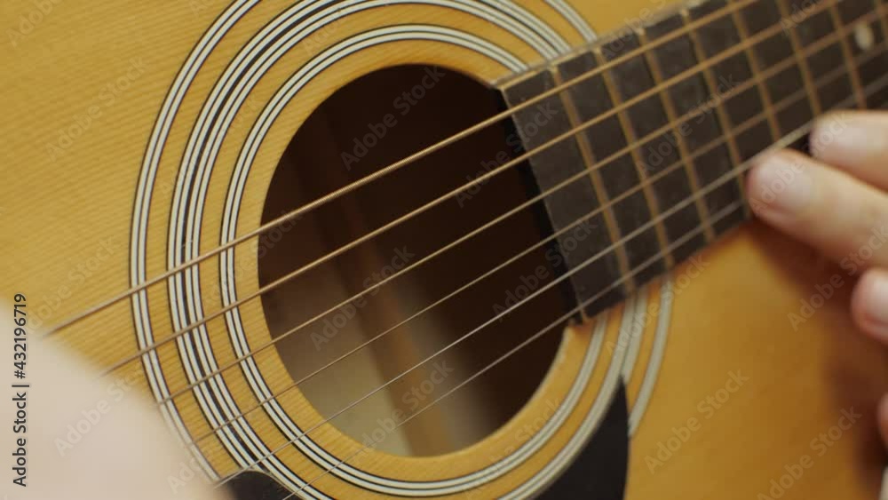 Male hands play an acoustic guitar solo. Close-up Male hands play an acoustic guitar solo. Close-up