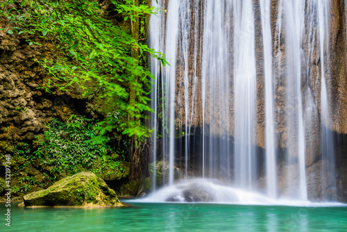 Waterfall and blue emerald water color in Erawan national park. Erawan Waterfall, Beautiful nature rock waterfall steps in tropical rainforest at Kanchanaburi province, Thailand