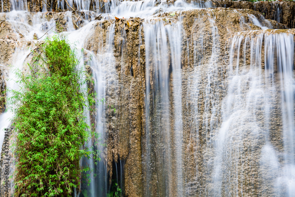 Waterfall and blue emerald water color in Erawan national park. Erawan Waterfall, Beautiful nature rock waterfall steps in tropical rainforest at Kanchanaburi province, Thailand Waterfall and blue emerald water color in Erawan national park. Erawan Waterfall, Beautiful nature rock waterfall steps in tropical rainforest at Kanchanaburi province, Thailand