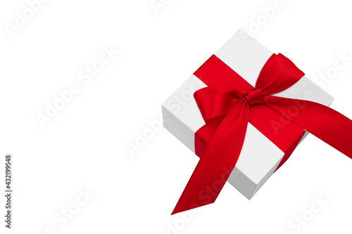 White gift box with red bow and satin ribbon isolated on white background. 
