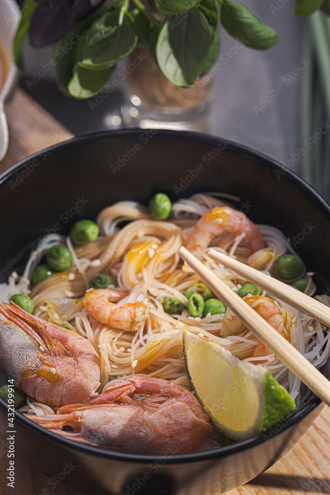 Asian dinner for two. Asian cuisine, rice noodles with seafood and vegetables