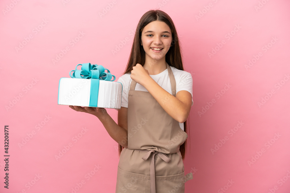 Little girl with a big cake over isolated pink background celebrating a victory Little girl with a big cake over isolated pink background celebrating a victory