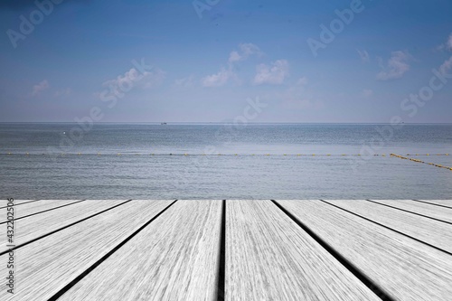 White wooden floor and sea and blue sky