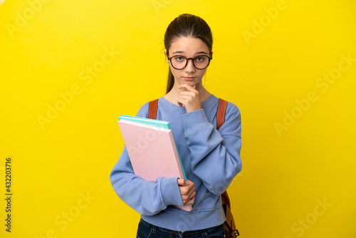 Student kid woman over isolated yellow background thinking