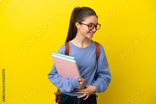Student kid woman over isolated yellow background smiling a lot