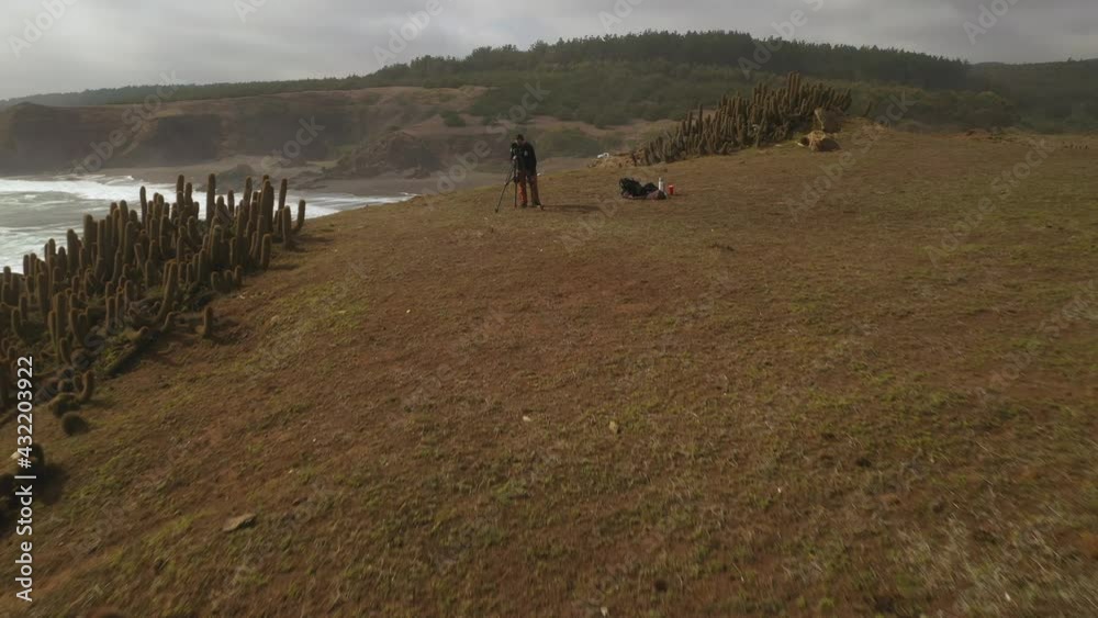 surf photographer in action, in pichilemu chile punta de lobos day was cloudy and cold during a storm surge. drone Footage travel In