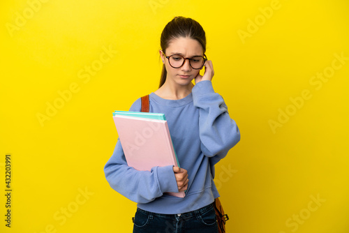 Student kid woman over isolated yellow background frustrated and covering ears