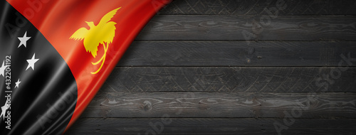 Papua New Guinea flag on black wood wall banner