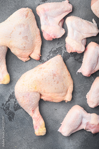 Raw uncooked chicken legs, drumsticks, on gray stone background, top view flat lay