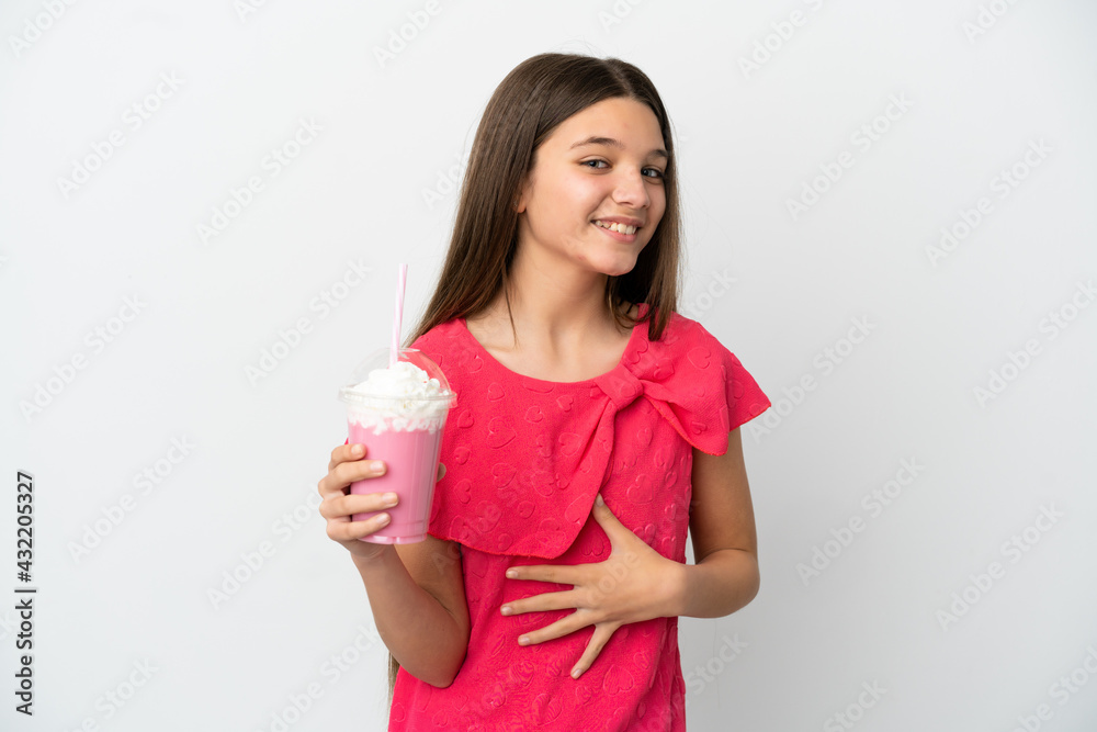 Little girl with strawberry milkshake over isolated white background smiling a lot Little girl with strawberry milkshake over isolated white background smiling a lot