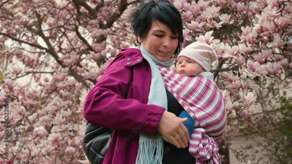 Woman with baby. Attachment parenting philosophy. Wraps options for distributing the child's weight in the carrier are most comfortable. Woman with baby. Attachment parenting philosophy. Wraps options for distributing the child's weight in the carrier are most comfortable.