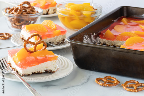 Close up of slices of peach jelly pretzel dessert ready for eating.