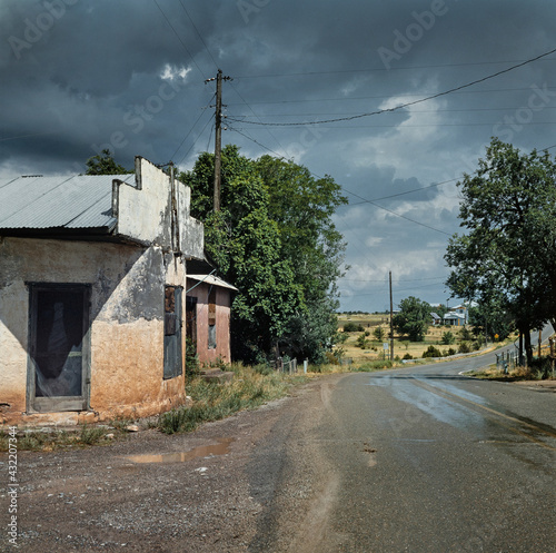 Abandoned shop and country road after the rain. Chilili Bernalillo County New Mexico USA 1990 photo