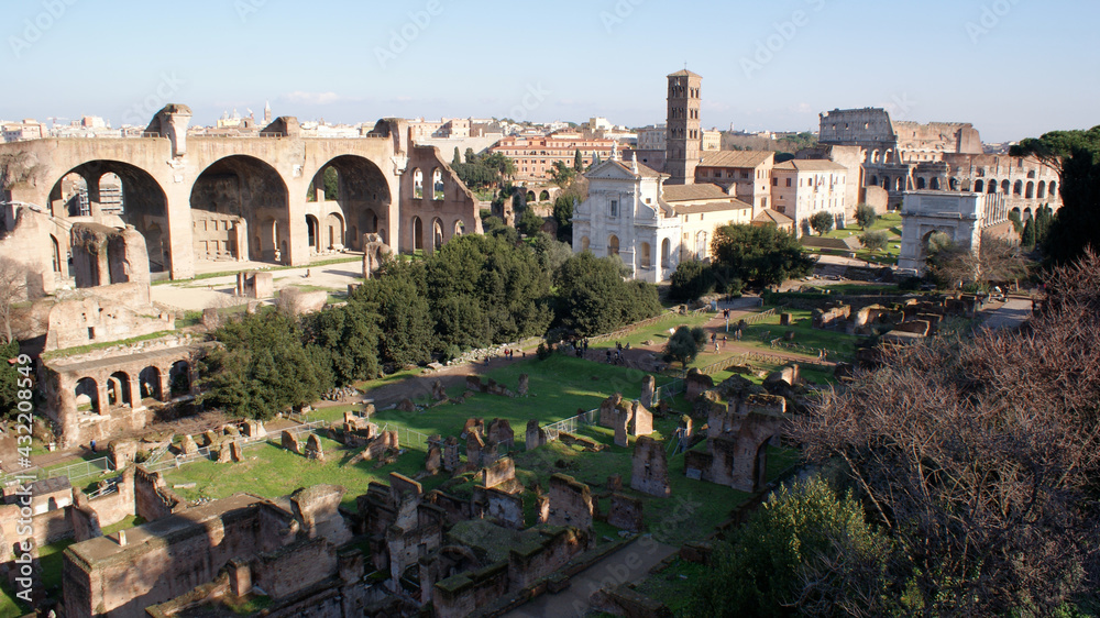 Rome, Italy, January 2007: Landscape of the Roman Forum from the hill. On background the Tito`s arch and the Coliseum.