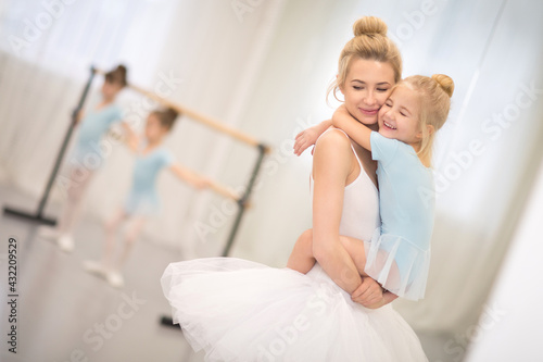 laughing mom and daughter in ballet lessons