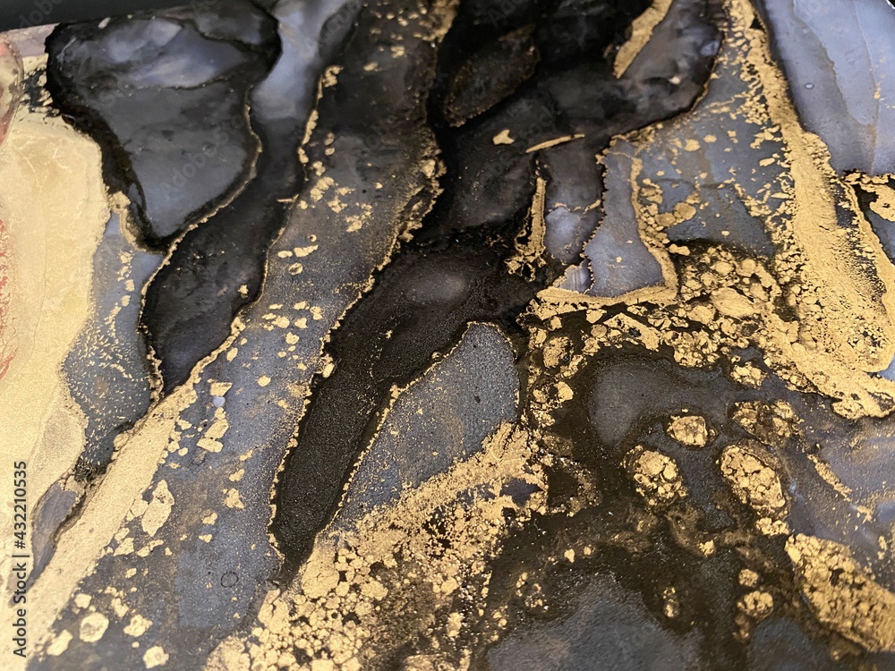 Abstract gold art with black and grey — fluid background with beautiful smudges and stains made with alcohol ink and golden pigment. Alcohol Ink texture resembles khokhloma, watercolor or aquarel