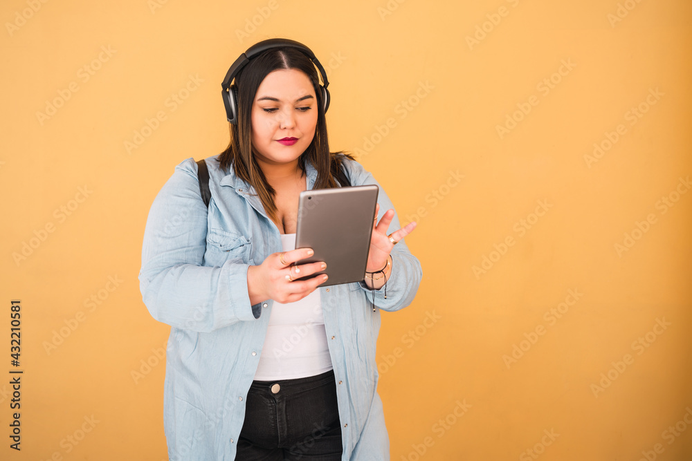 Fototapeta premium Woman listening music with headphones and tablet.