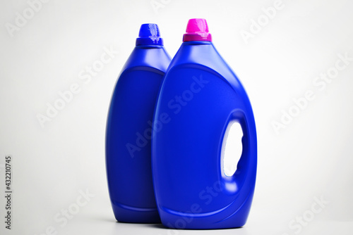 Two cleaning products, isolated over white. Plastic bottle blue cap isolated on white. Blue plastic bottles of cleaning products.