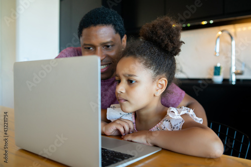 A father helping his daughter with homeschool.