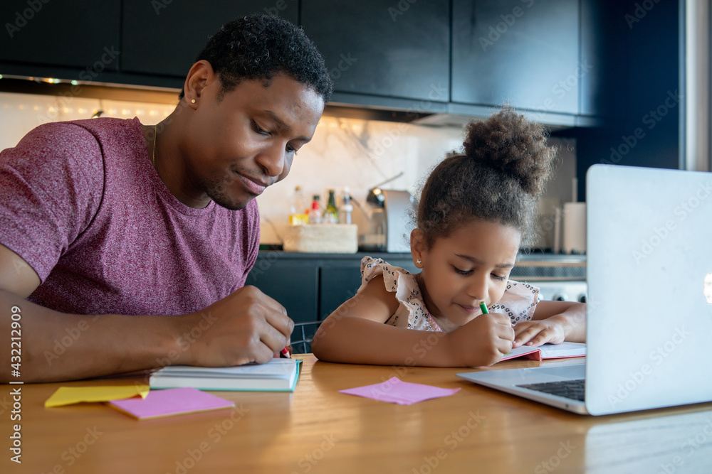 A father helping his daughter with homeschool. A father helping his daughter with homeschool.