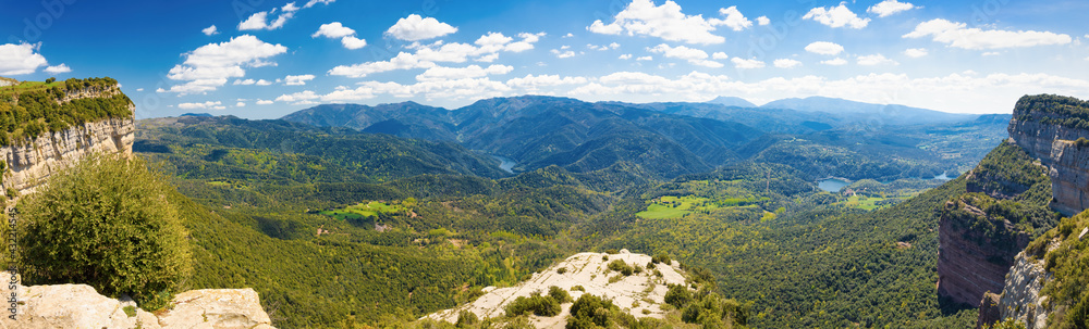 Great panoramic view of the Guilleries natural park seen from the Tavertet cliffs, with the Sau reservoir dam and the entrance of the Ter river to the Susqueda reservoir. Catalonia, Spain