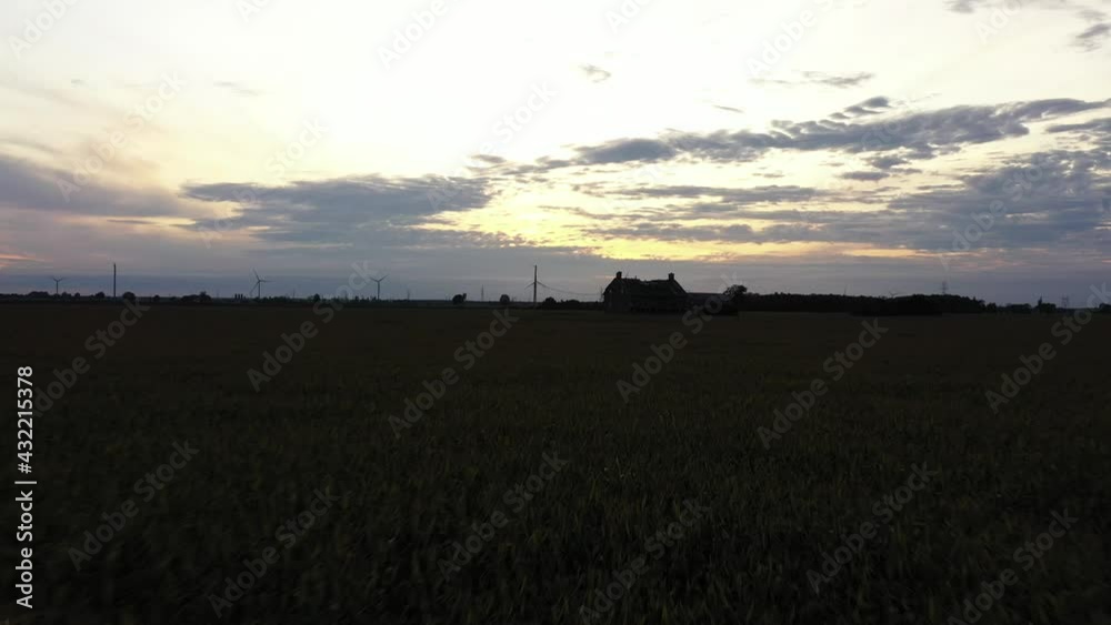 abandonded house in middle of cornfield at sunset low approaching flight abandonded house in middle of cornfield at sunset low approaching flight