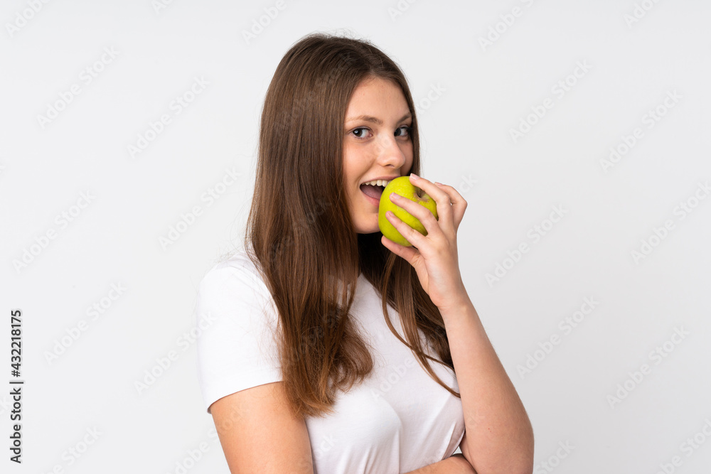 Teenager caucasian girl isolated on white background eating an apple Teenager caucasian girl isolated on white background eating an apple