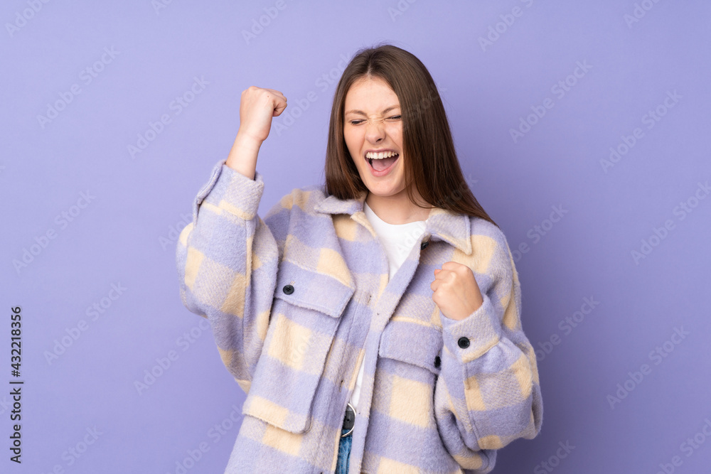 Teenager caucasian girl isolated on purple background celebrating a victory Teenager caucasian girl isolated on purple background celebrating a victory