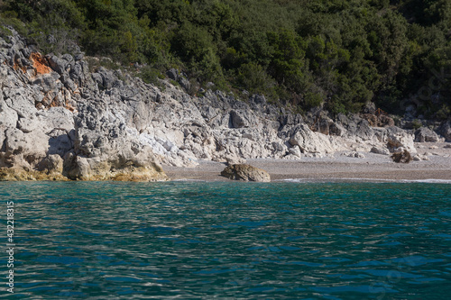.View of the strip of the sea, small beach and mountains surrounded by vegetation, Albania. Travel and vacation theme