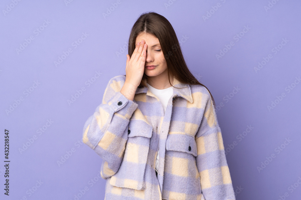 Teenager caucasian girl isolated on purple background with headache