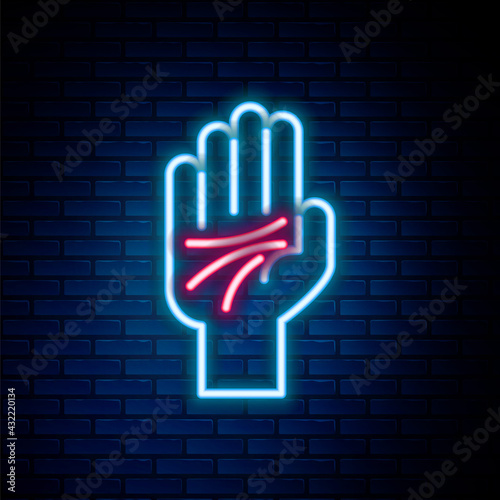 Glowing neon line Palmistry of the hand icon isolated on brick wall background. Colorful outline concept. Vector