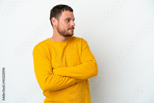 Young Brazilian man isolated on white background looking to the side