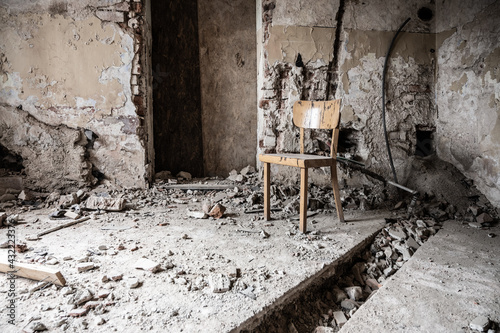 Old wooden chair in devasted abandoned room